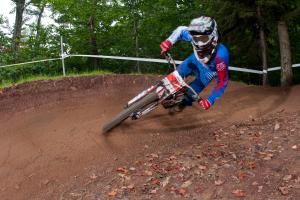a man riding a dirt bike on a dirt track at Highland House in Snowshoe