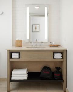 a bathroom with a sink and a mirror at The Godfrey Hotel & Cabanas Tampa in Tampa