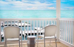 a dining room table with chairs and umbrellas at Oceans Edge Key West in Key West