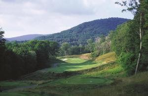 a golf course in the mountains with a green at Inn at Snowshoe in Snowshoe