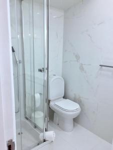 a bathroom with a toilet and a glass shower at Flipflops Apartment in Nazaré +17 photos