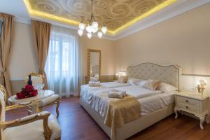 a bedroom with a large bed with a gold ceiling at Central Square Heritage Hotel in Split