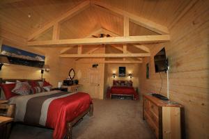 a bedroom with a bed in a wooden cabin at Denali Tri-Valley Cabins in Healy