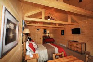 a bedroom with a bed and a dresser at Denali Tri-Valley Cabins in Healy