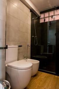 a bathroom with a toilet and a sink and a shower at TuttiFruttiaApt in Nerja +10 photos