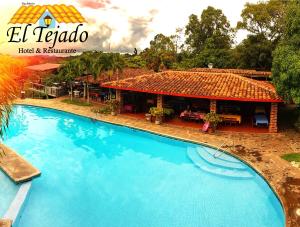 a large swimming pool in front of a building at El Tejado in Suchitoto