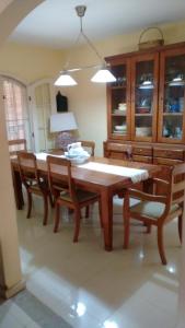 a dining room with a wooden table and chairs at Casa do Bosque, 367 in Rio das Ostras