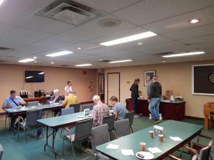 a group of people sitting at tables in a room at Airport Inn in Port Hardy