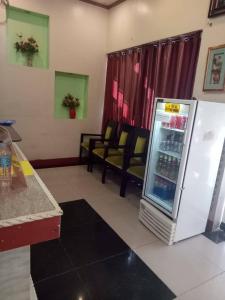 a room with a refrigerator and some chairs at Jeamco Royal Hotel-General Santos in General Santos