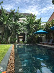 a swimming pool in front of a villa at Vina Beach Pool Villas in Hoi An