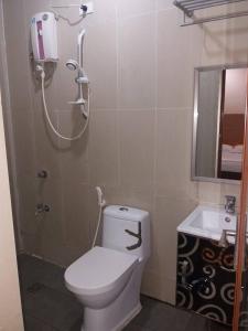 a bathroom with a white toilet and a sink at Asia Novo Boutique Hotel - Catbalogan in Catbalogan