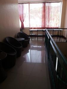 a room with chairs and a table and a window at Asia Novo Boutique Hotel - Catbalogan in Catbalogan