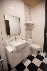 uma casa de banho com um lavatório, um WC e um espelho. em NEAR B&B em Hualien City