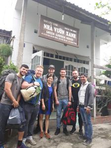 a group of people standing in front of a building at Green garden house in Hoi An