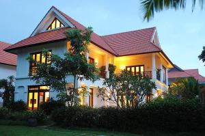 a white house with a red roof at Champa Villa with private pool at Furramar Danang in Danang