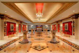 a large lobby with a chandelier and a dance floor at Grand Hyatt Muscat in Muscat