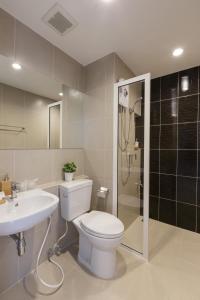 a bathroom with a toilet and a sink and a shower at @S115 Residence in Samutprakarn