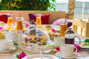 a table topped with plates of food and drinks at Villa Lala in Kiwengwa