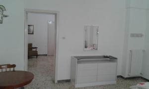 a white room with a table and a mirror on the wall at vacanza nel salento1 in Matino +45 photos