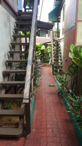 a brick pathway with stairs in a building with plants at T Star Cottage Langkawi in Pantai Cenang