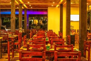 a dining room with wooden tables and chairs at Oak Ray Ella Gap Hotel in Ella