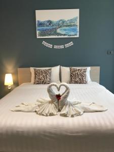 a bed with two swans made to look like a heart at The Phu View at Aonang in Ao Nang Beach