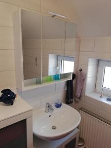 a bathroom with a sink and a mirror at Haus Bruni in Graftlage +18 photos