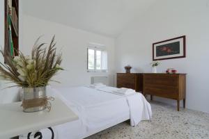 Postel nebo postele na pokoji v ubytování Agriturismo di Serragiumenta