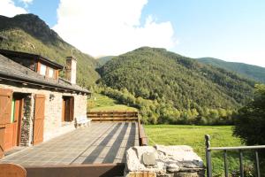 a balcony of a house with mountains in the background at Llorts, Casa Rustica, Ordino, Zona Vallnord in Llorts