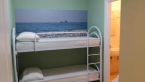 En eller flere senge i et værelse på Lacona Casa Franca