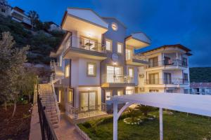 a large white building with a clock on it at Kybele Suites in Kas