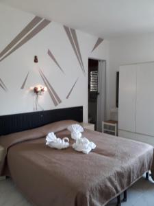 a bedroom with a bed with two towels on it at Hotel Santa Caterina in Gizzeria