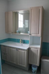 uma casa de banho com um lavatório e um espelho em 18B Rue Winston Churchill em Jonzac