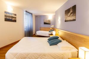 a bedroom with two beds in a room at Hotel All'Arco in Trieste