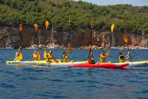 a group of people in kayaks in the water at RVHotels Nieves Mar in L'Escala