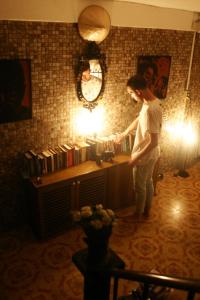 a woman standing in a room with a light at Born Free Hostel in Bangkok