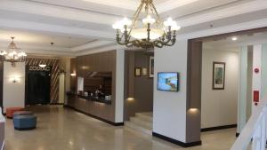 a lobby with a chandelier in a building at Harbour View Hotel in Kuching