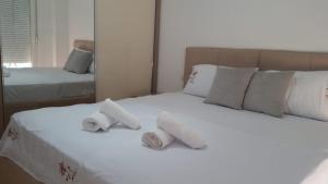 Кровать или кровати в номере Shengjin - Helios Home