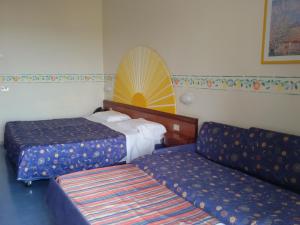 Postel nebo postele na pokoji v ubytování Sporting Baia Hotel