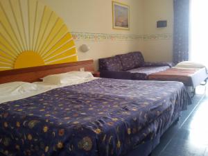 Postel nebo postele na pokoji v ubytování Sporting Baia Hotel