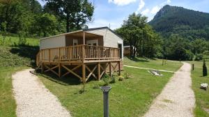 a small cabin with a porch and a deck at Camping White Rock in Castellane