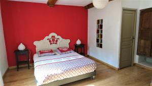 a bedroom with a bed with a red wall at Camping White Rock in Castellane