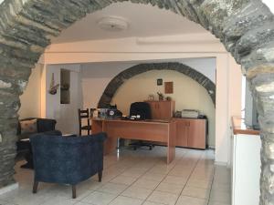 an archway in a room with a desk in a room at Manto Apartments in Tinos Town