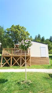 a house with a large deck and a building at Camping White Rock in Castellane