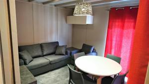 a living room with a couch and a table at Camping White Rock in Castellane