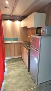 a kitchen with a refrigerator and a stove in it at Camping White Rock in Castellane