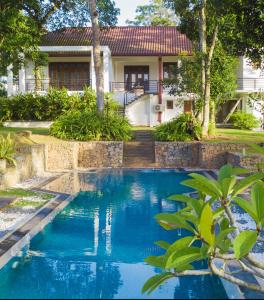 a swimming pool in front of a house at Villa Crystals in Colombo