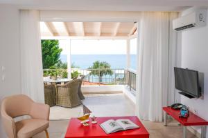 a living room with a view of the ocean at Acrotel Athena Villa in Elia
