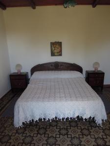 a bedroom with a large bed with two night stands at Agriturismo Cuca in Polizzi Generosa