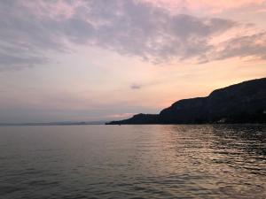 a view of a body of water at sunset at Appartamenti Villa Andrea in Garda